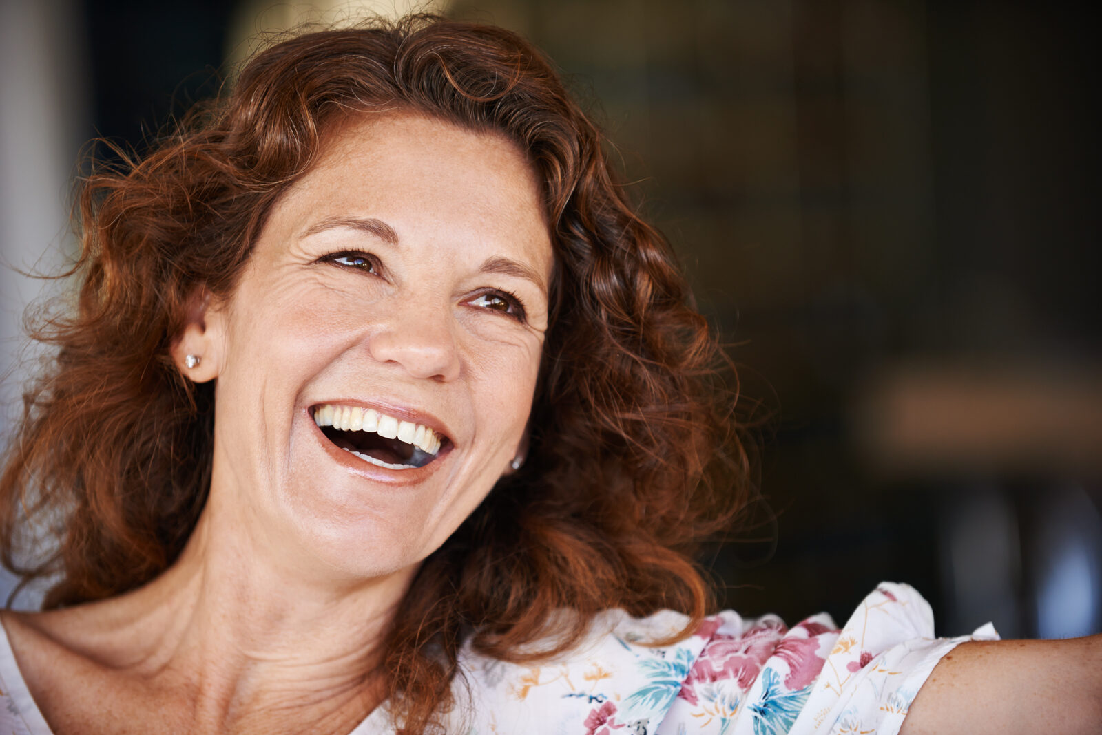 Laughing woman with curly red hair