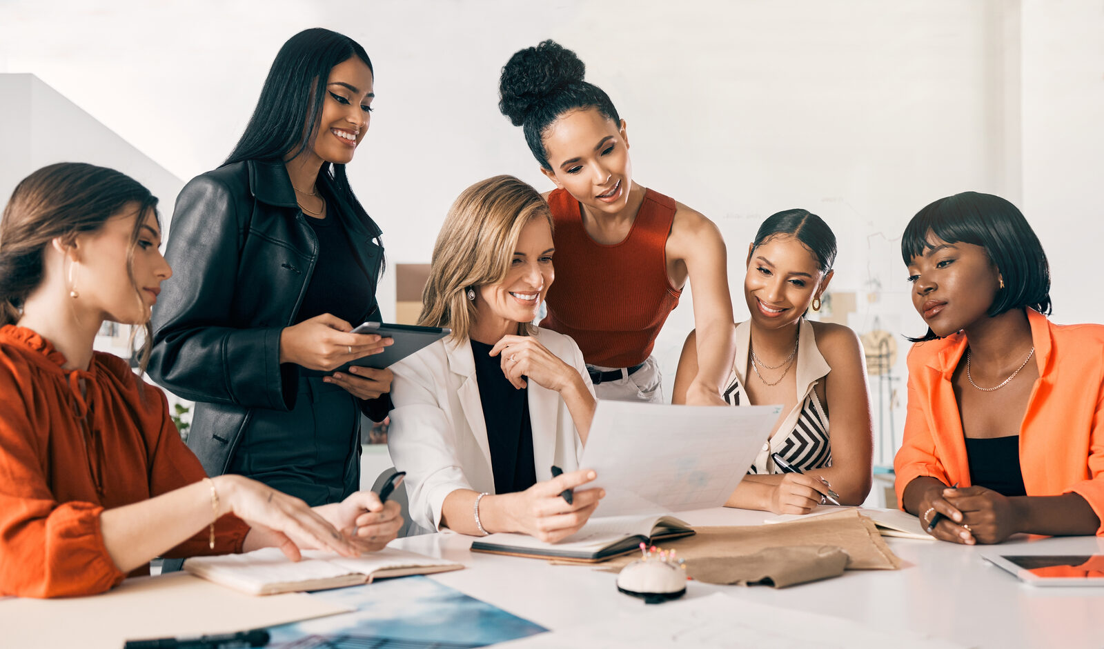 Professional women reviewing work together at a desk