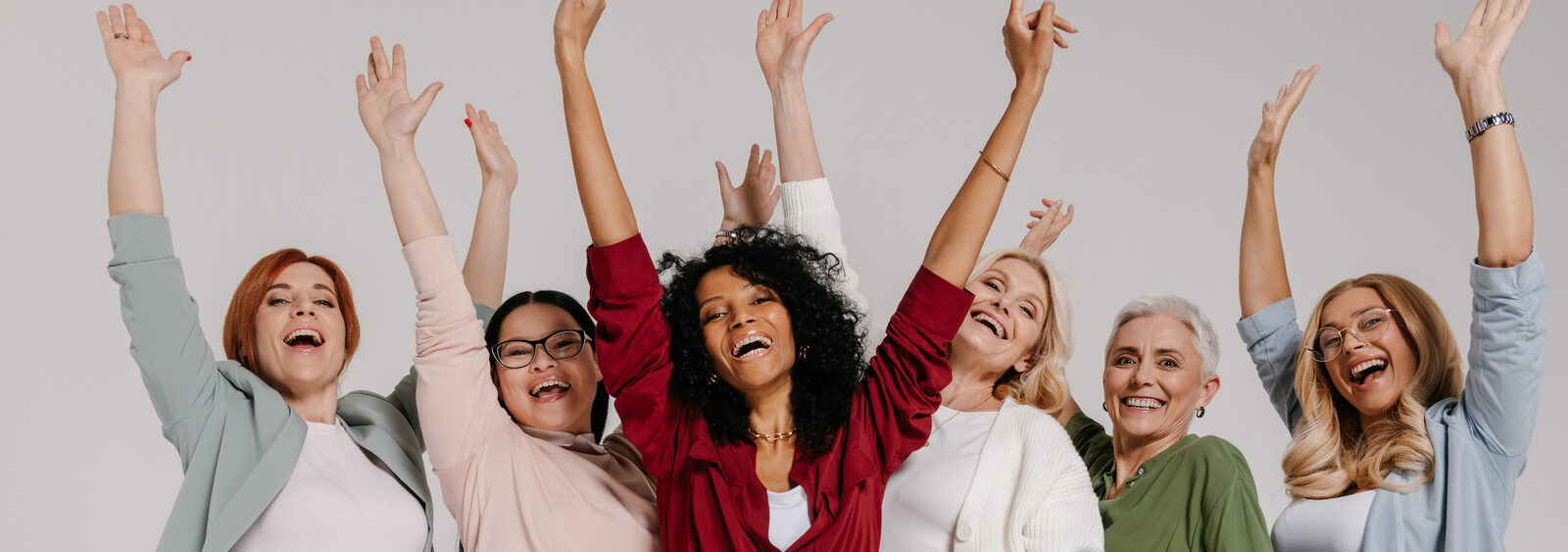 Group of women cheering with raised arms